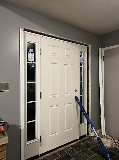 A white door being installed in a room