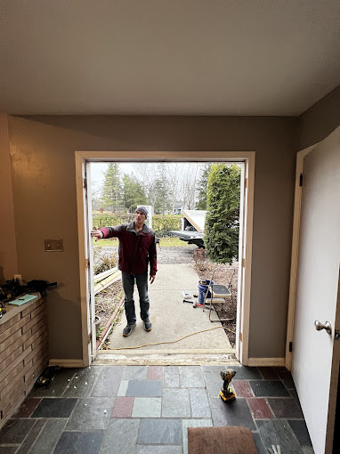 A man standing in the doorway of a house